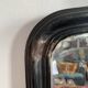 Miroir Napoléon III en bois noir à fronton