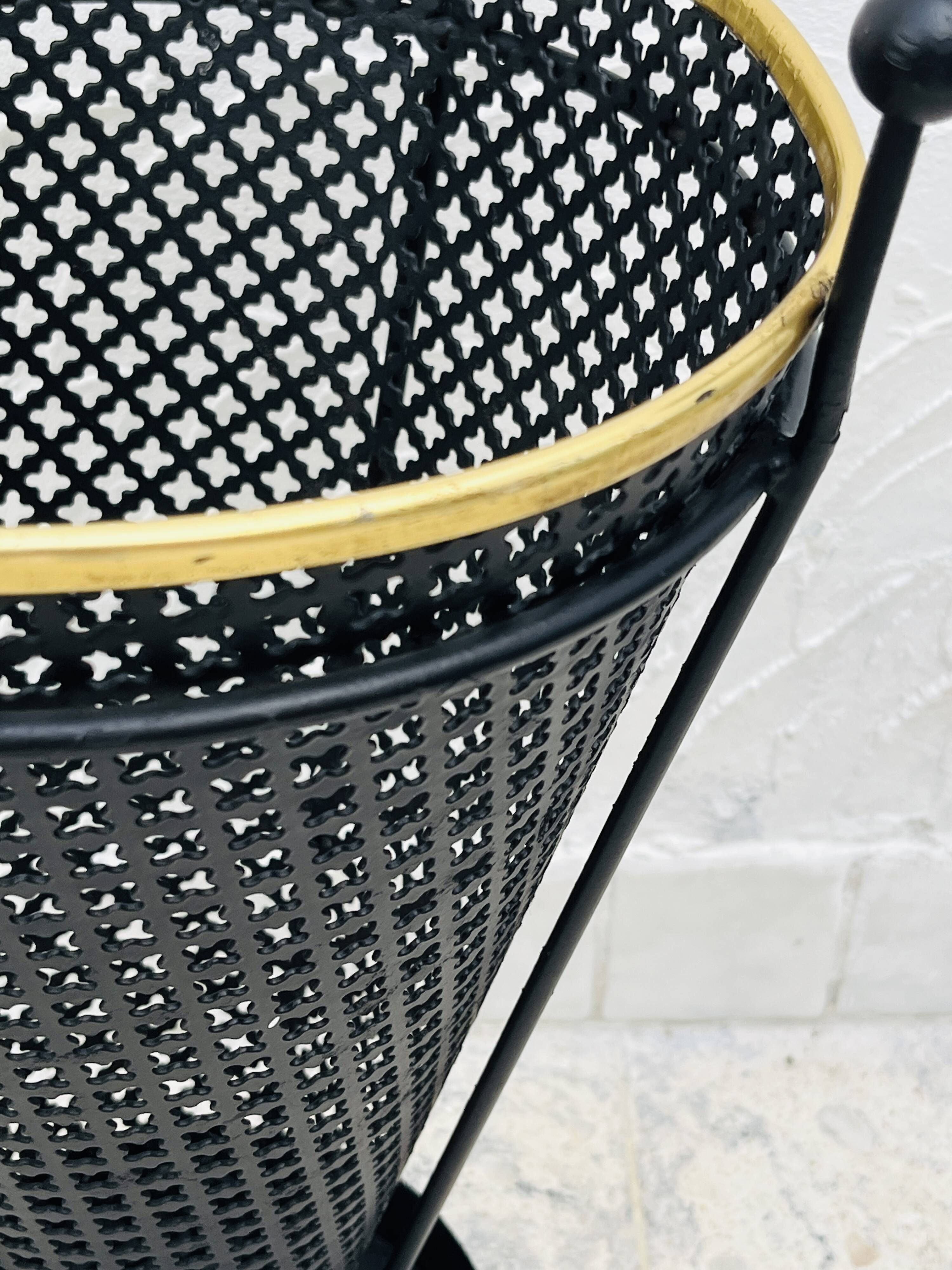 Vintage black perforated metal and brass umbrella stand