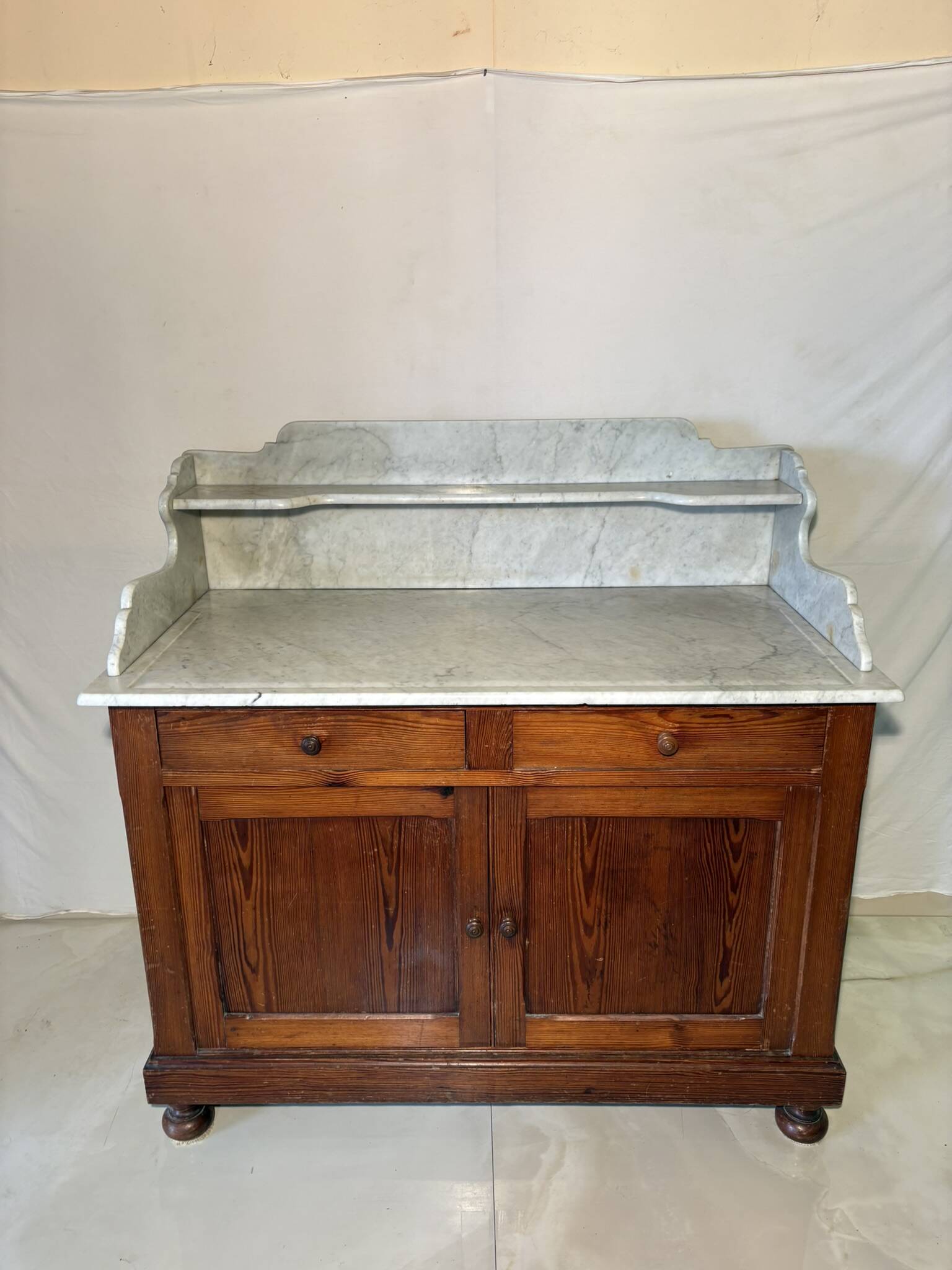 Antique wood and marble kitchen sideboard with carved backsplash