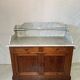 Antique wood and marble kitchen sideboard with carved backsplash