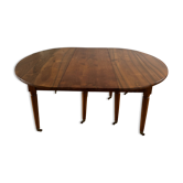 Solid wood dining table with multiple extensions.