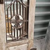 Chiseled teak door with openwork wrought iron panels