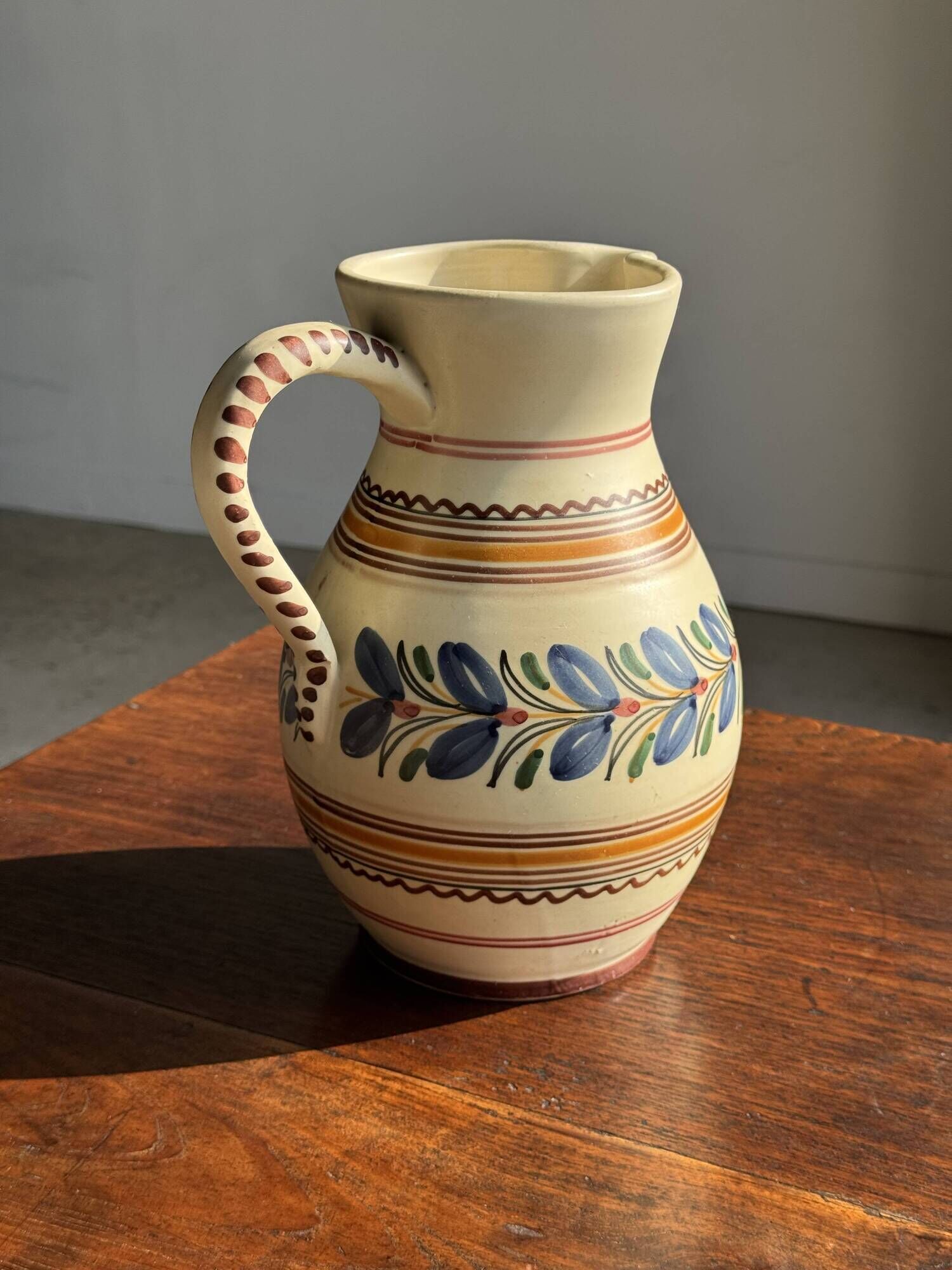 Beige carafe with stylized blue flower friezes