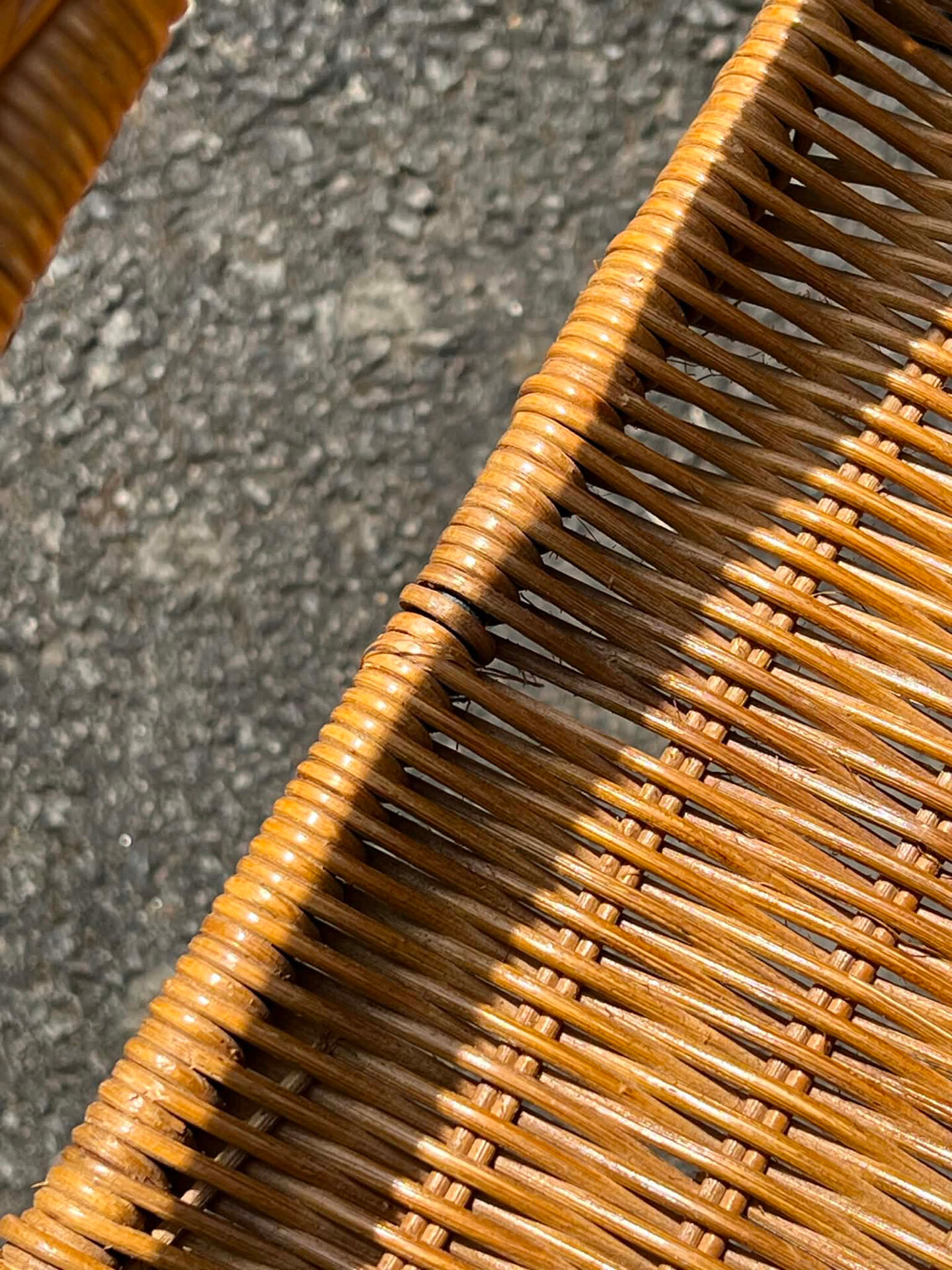 Wicker and black wrought iron armchair