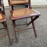 4 cane-seated solid wood folding chairs to be repaired.