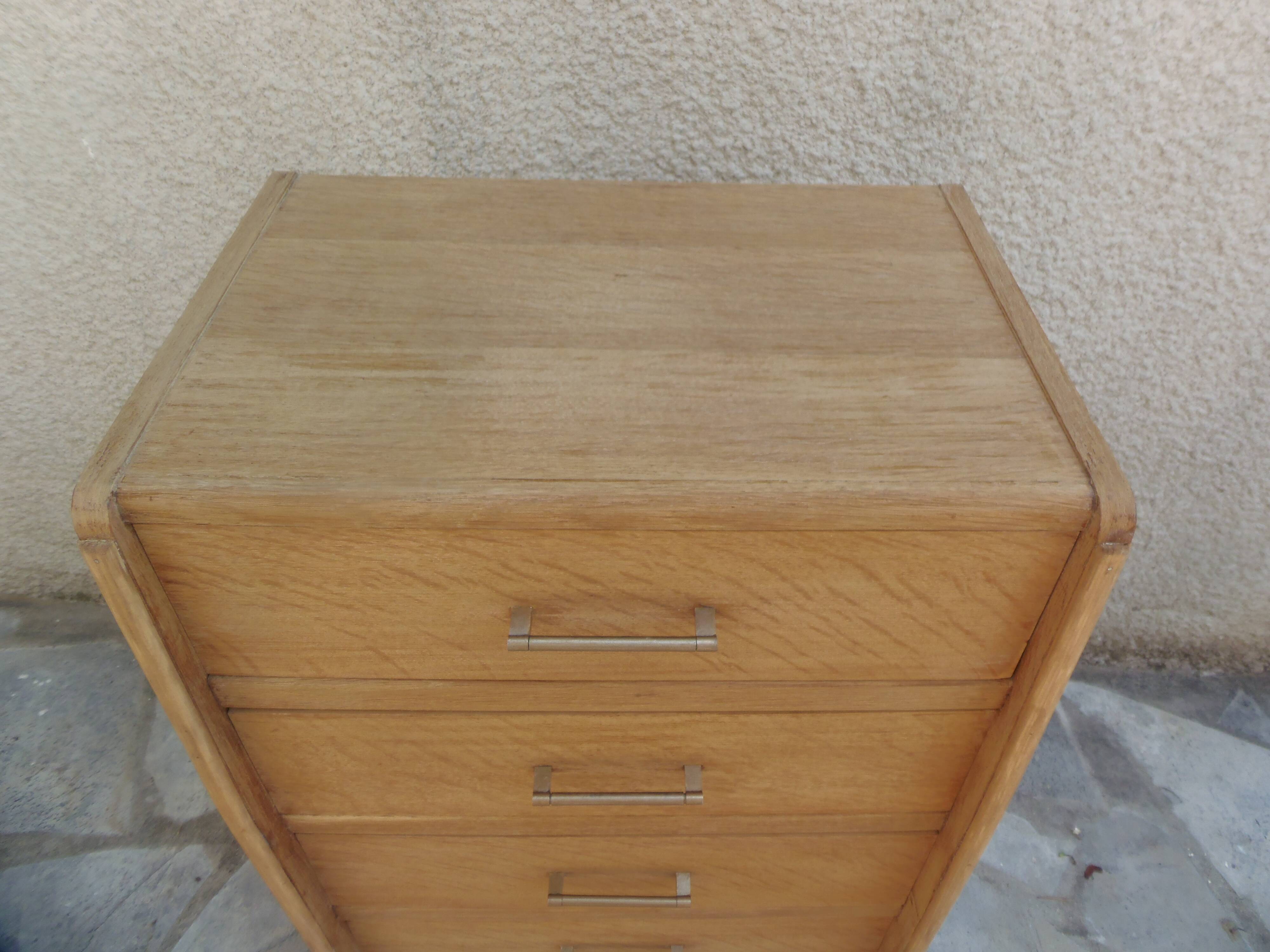 Vintage chest of drawers in raw wood.