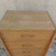 Vintage chest of drawers in raw wood.