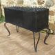Black perforated metal planter from the 1950s
