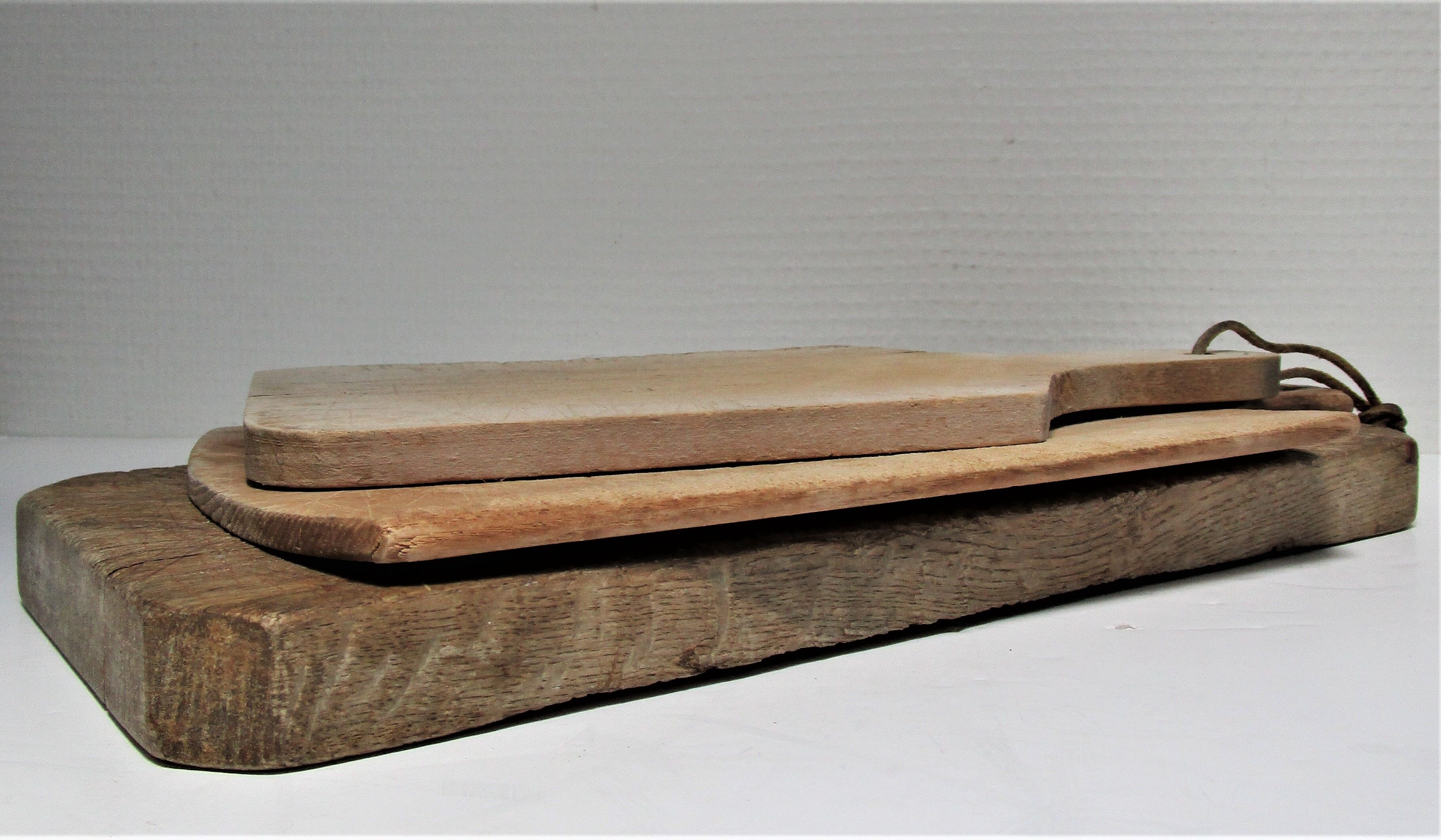 three vintage patinated solid wood cutting boards