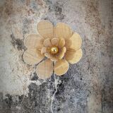Flower wall light made of rattan and raffia petals
