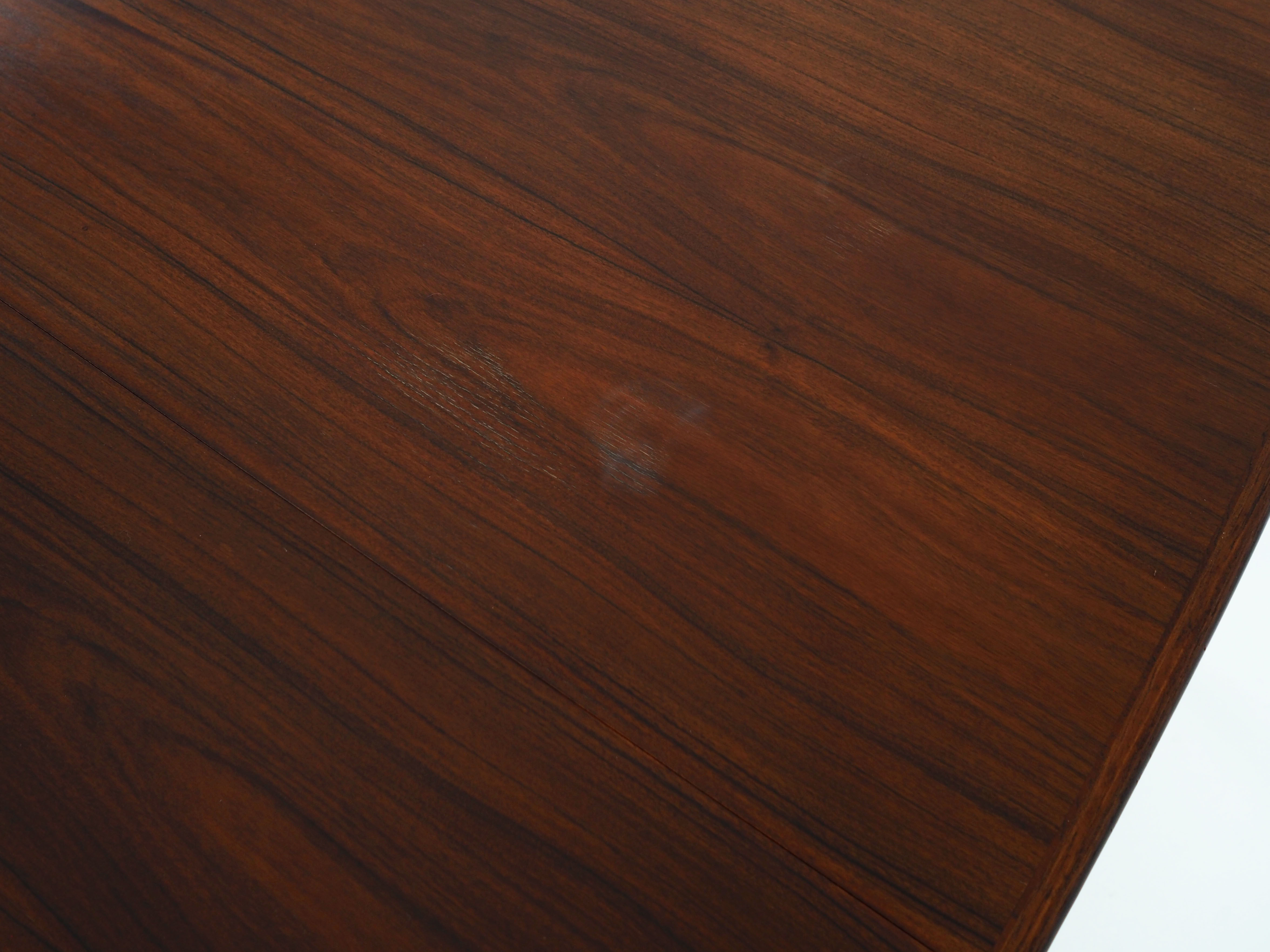 Oval table, covered with rosewood veneer.Design of the 70s