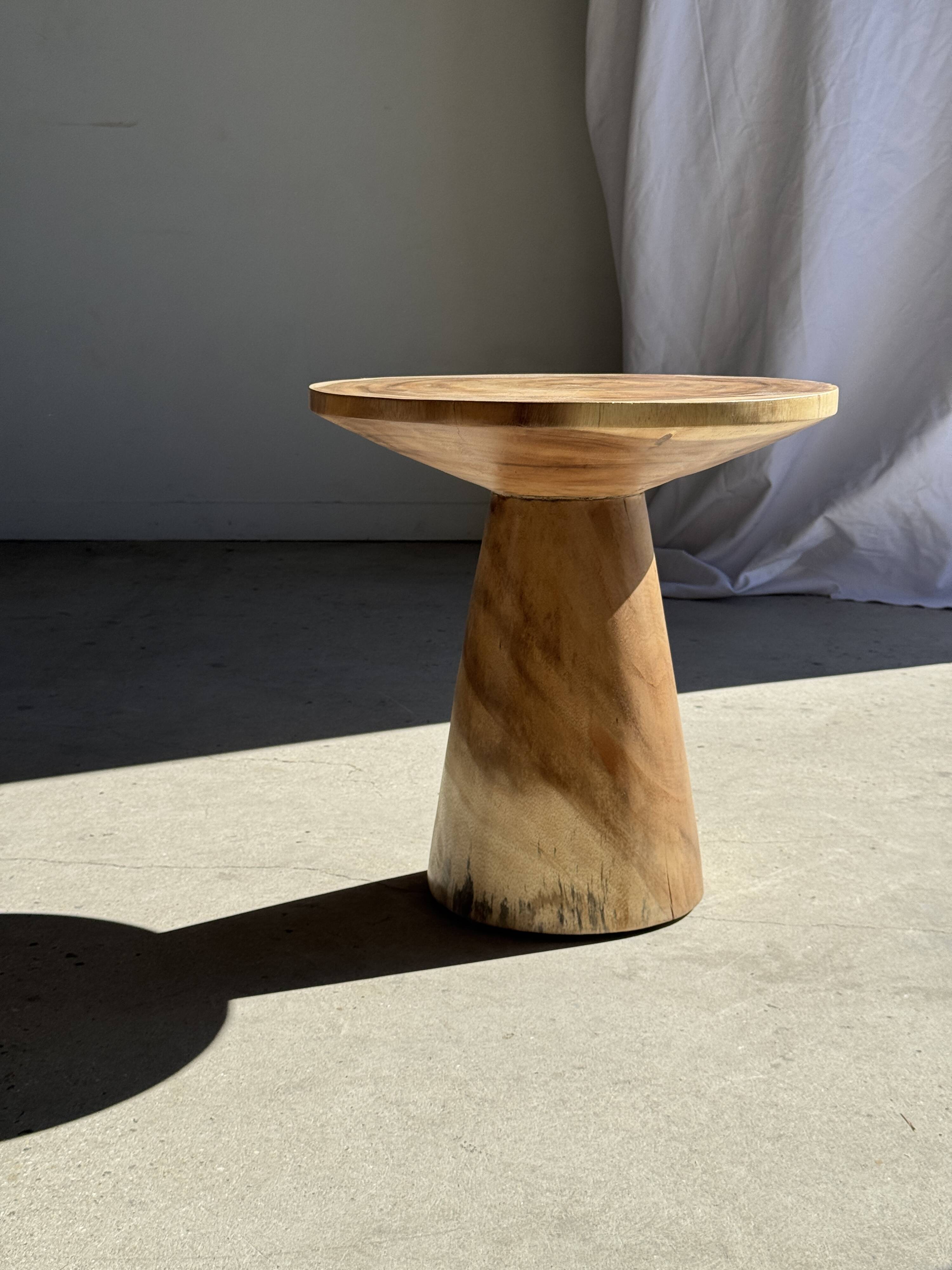 Natural solid suar side table (monoxyle) with a minimal conical base.