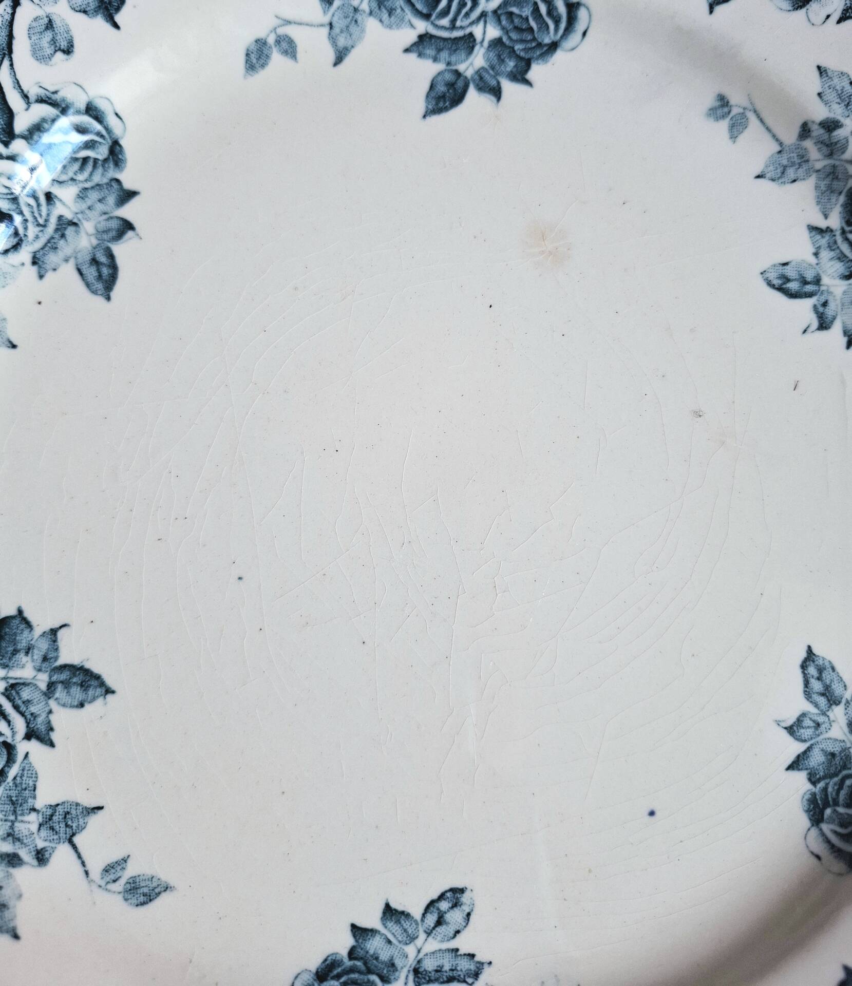 Old mismatched flat plates made of ironstone earthenware.