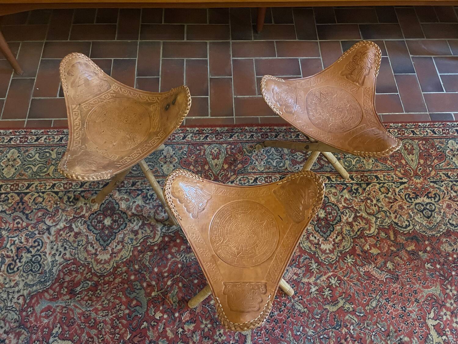 Vintage Mexican tripod stools in bamboo and leather.