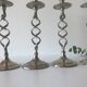 Four twisted silver candlesticks
