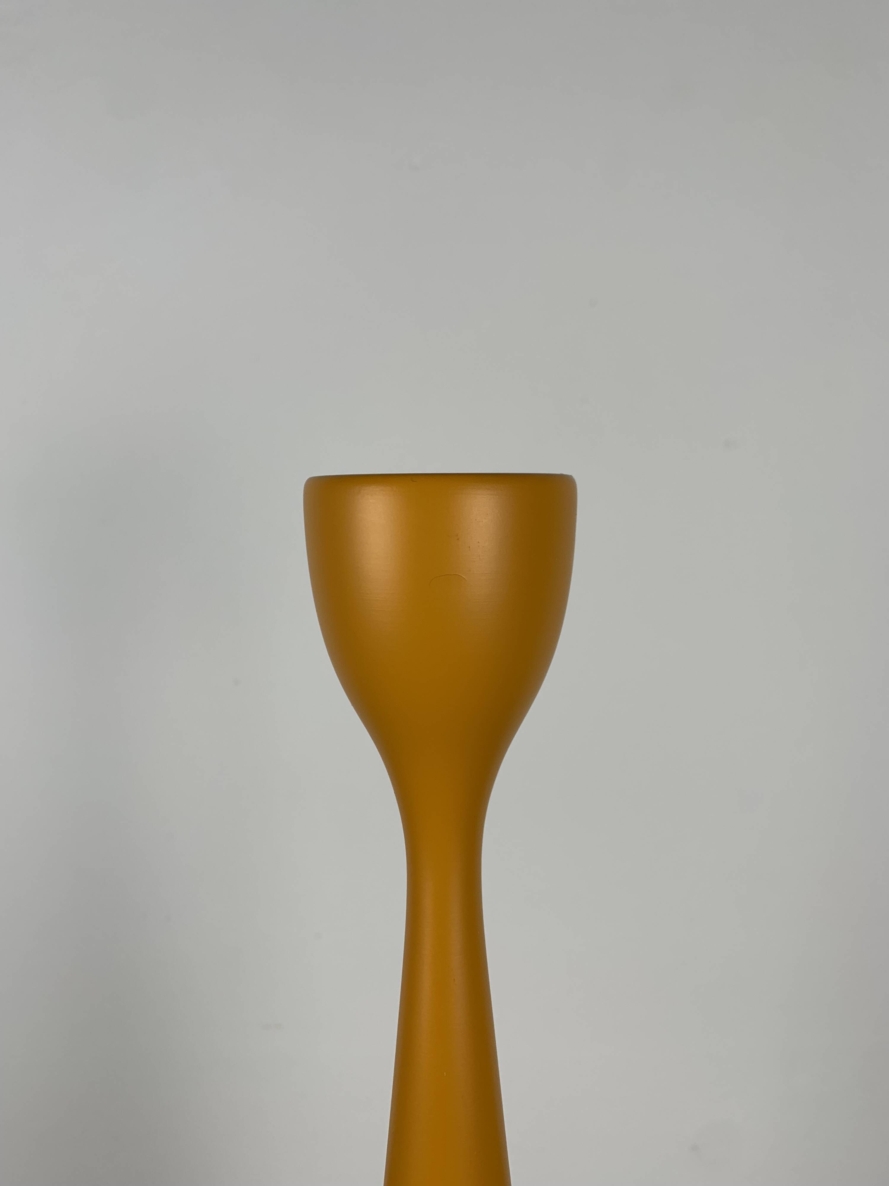 Large candle holder in orange-yellow lacquered wood