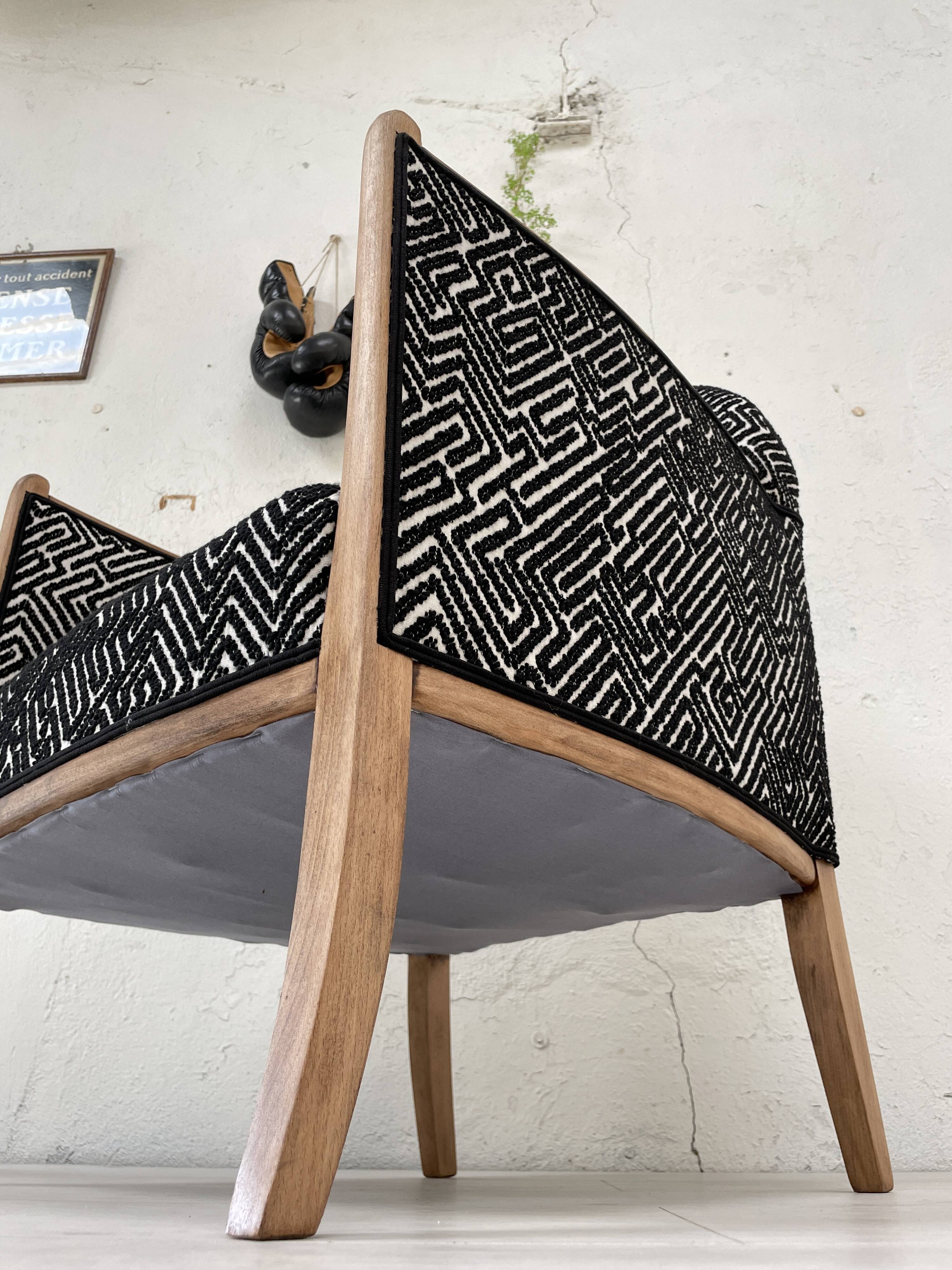 Club armchair in wood and fabric.