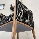 Club armchair in wood and fabric.