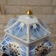 Decorative pot jar with a lid featuring a blue floral pattern and gilding.