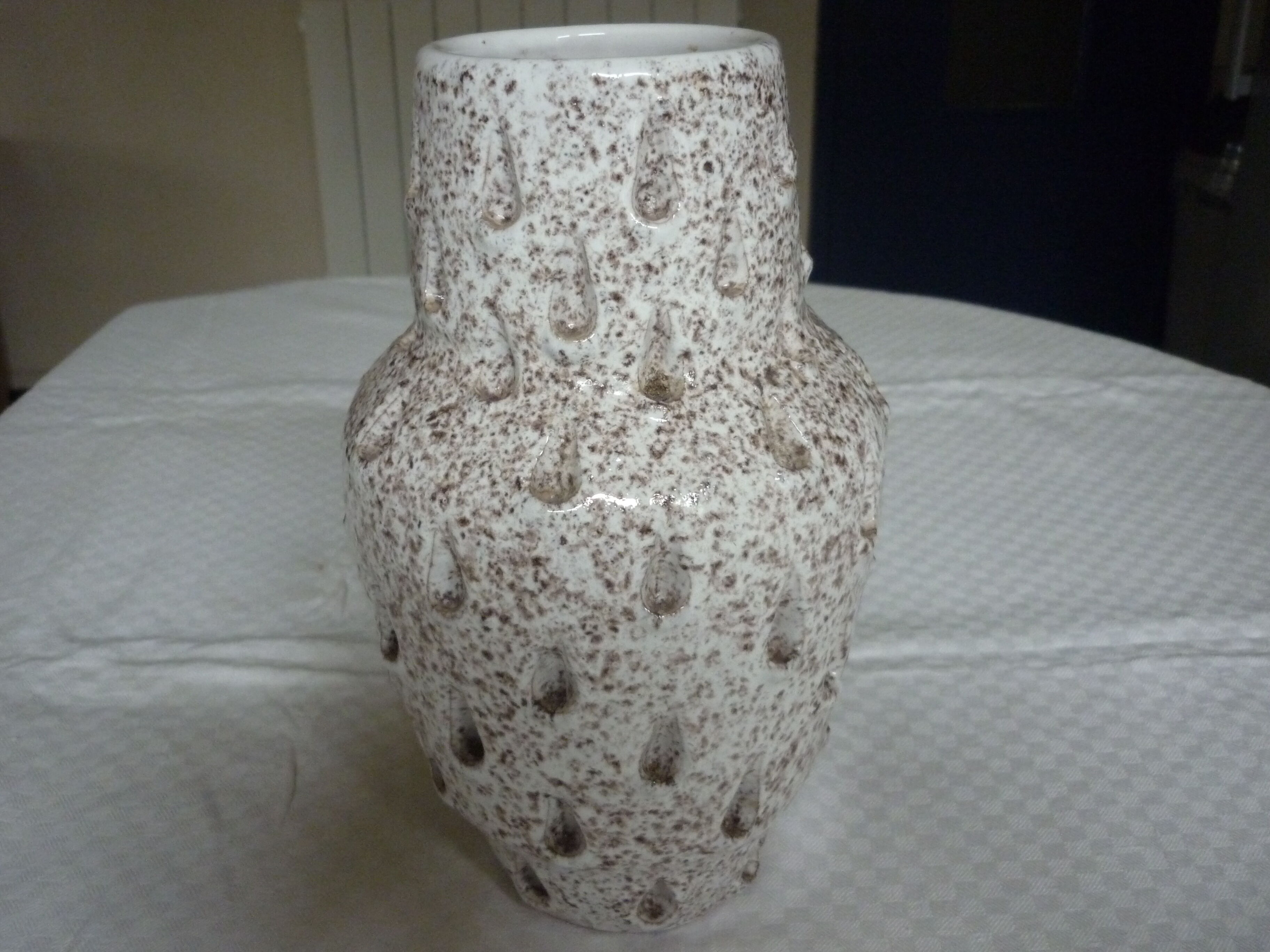 Spotted white ceramic vase with hollow form of tears