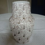 Spotted white ceramic vase with hollow form of tears