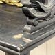 Blackened wooden shelf.