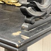 Blackened wooden shelf.
