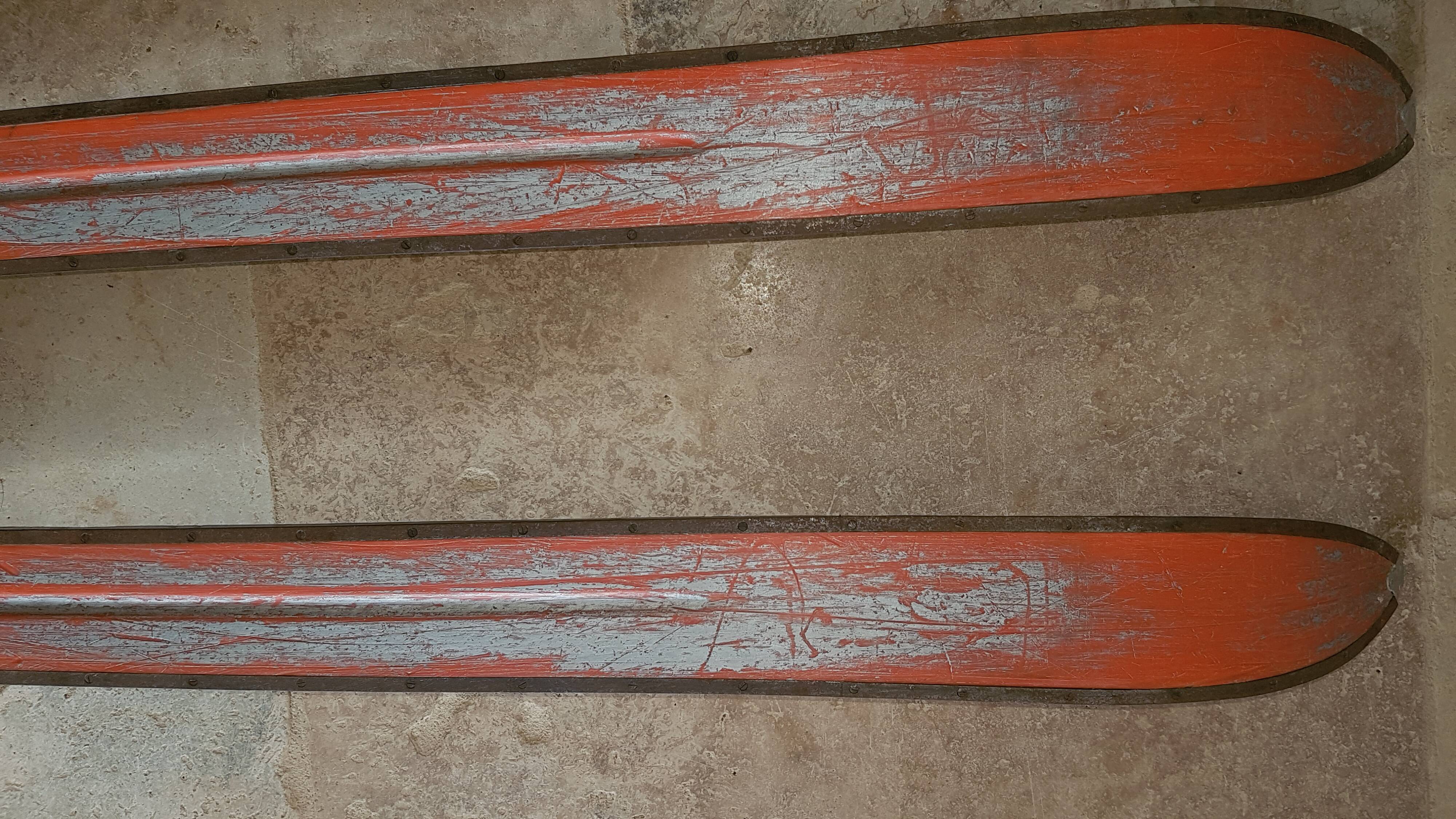 Old skis wooden and its pair of sticks