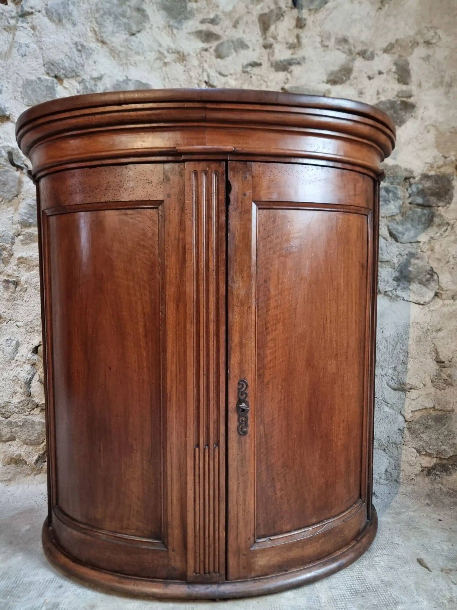 Antique demi-lune cabinet in walnut, late 18th century, French château.