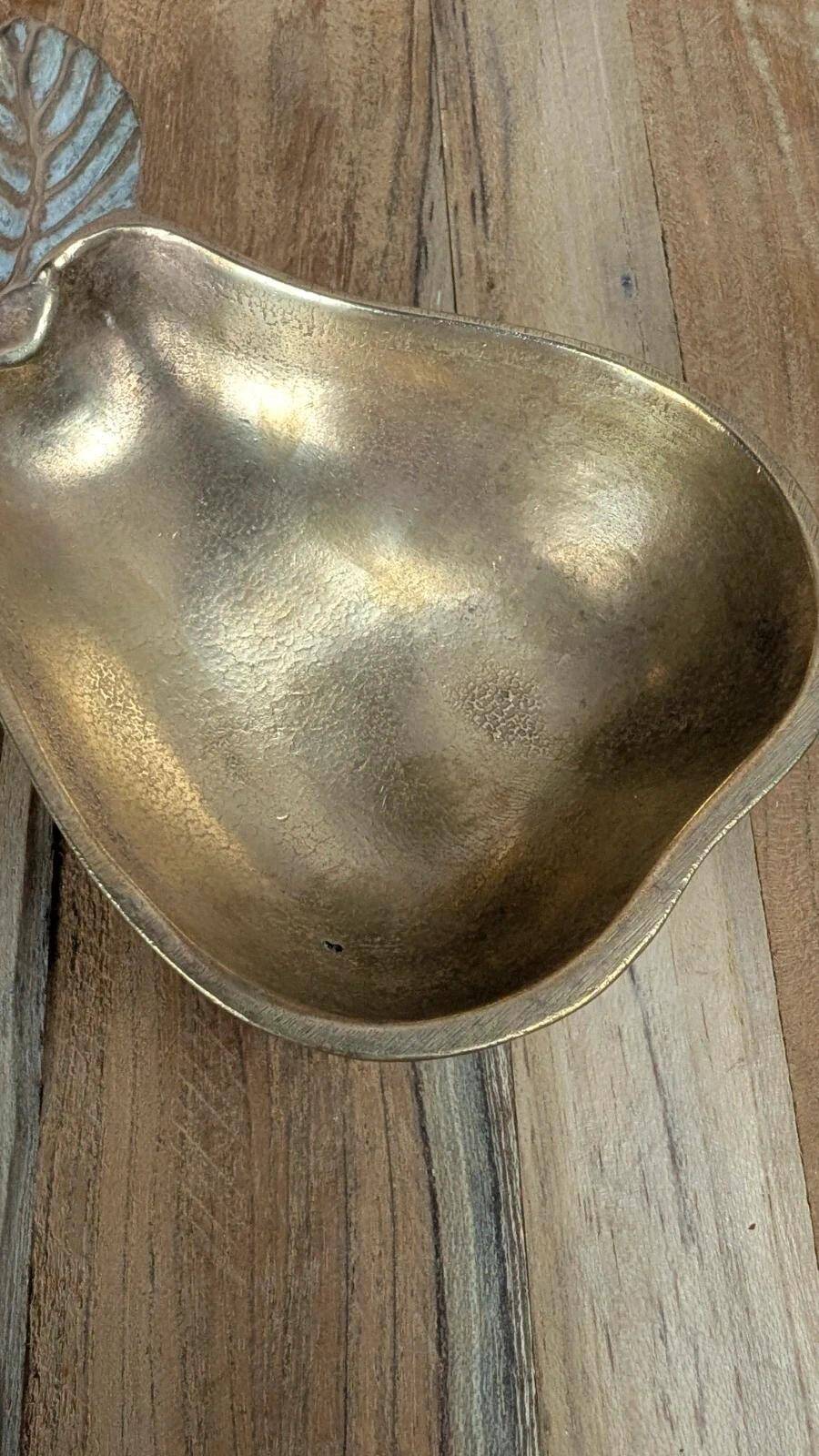 Small vintage brass trinket dish in the shape of a pear.