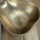 Small vintage brass trinket dish in the shape of a pear.