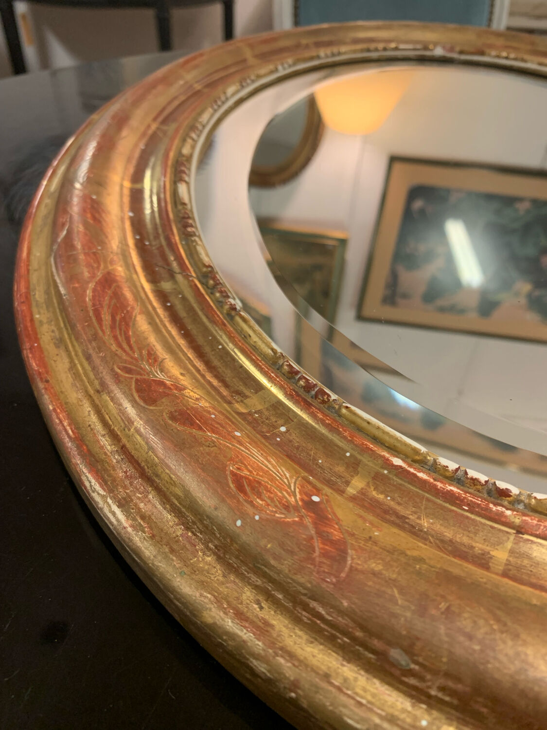 Golden oval mirror