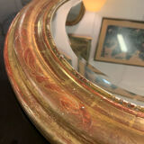 Golden oval mirror
