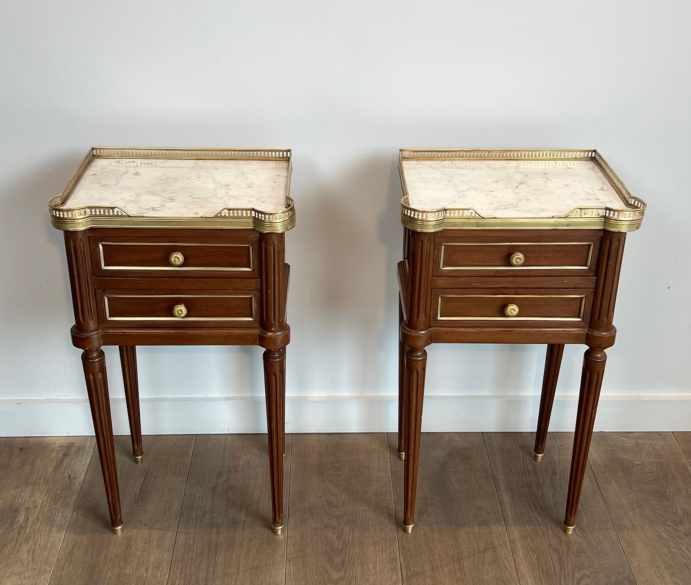 Pair of mahogany and brass side tables or bedside tables with Carrara marble tops.