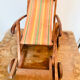 Vintage wooden folding doll's deckchair on wheels