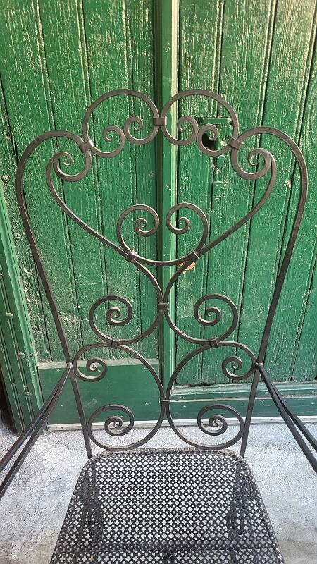 Pair of black wrought iron armchairs