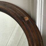Old oval mirror with wooden frame