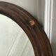 Old oval mirror with wooden frame