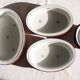 Set of 4 white porcelain dishes with blue decorations and wicker stands