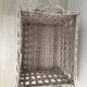 Wicker laundry basket on vintage wooden wheels