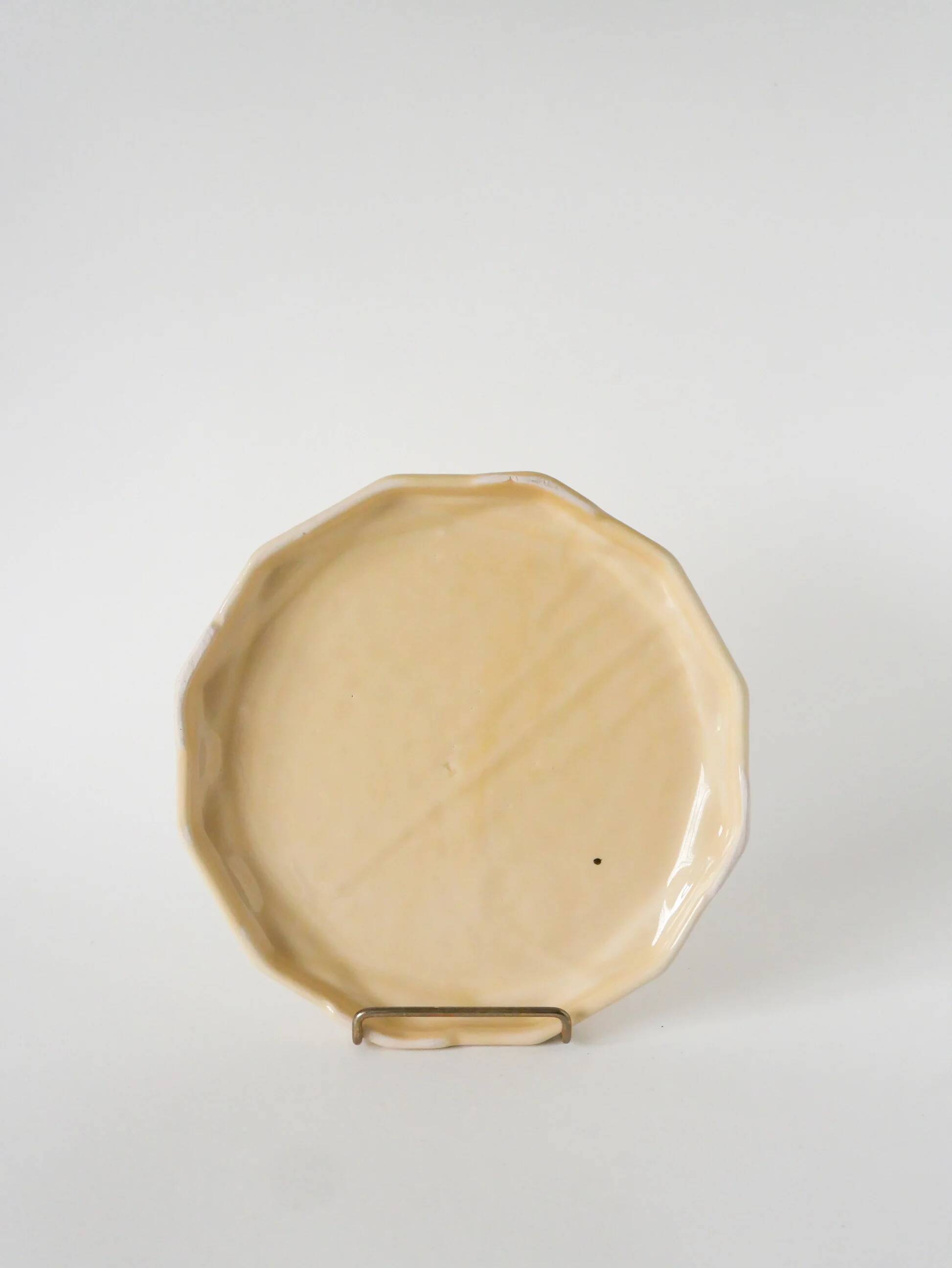 Ceramic trivet, butter yellow and gold, 1960.