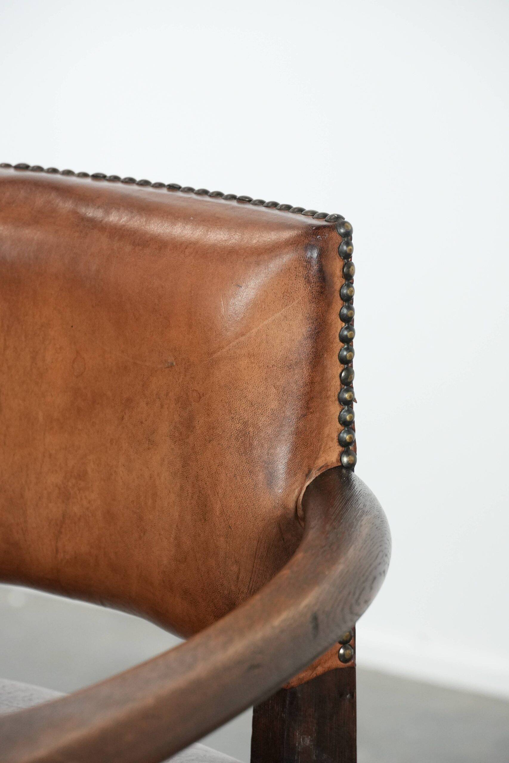 Elegant antique sheepskin leather desk chair with a heavy wooden frame