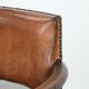 Elegant antique sheepskin leather desk chair with a heavy wooden frame
