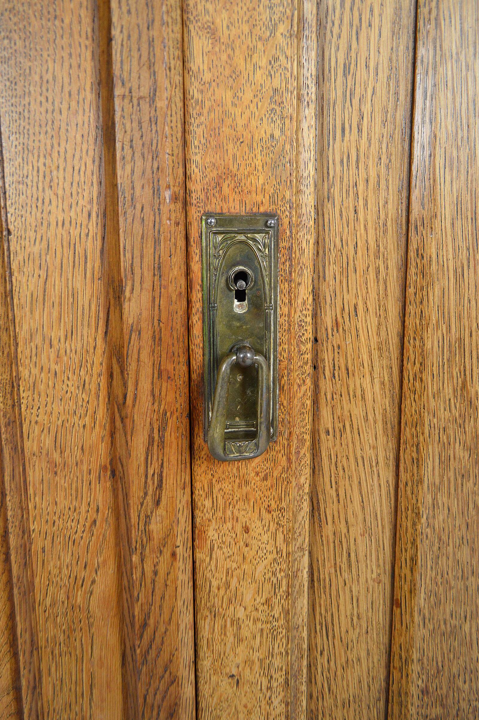Art Nouveau oak buffet and dinanderie panels, circa 1910