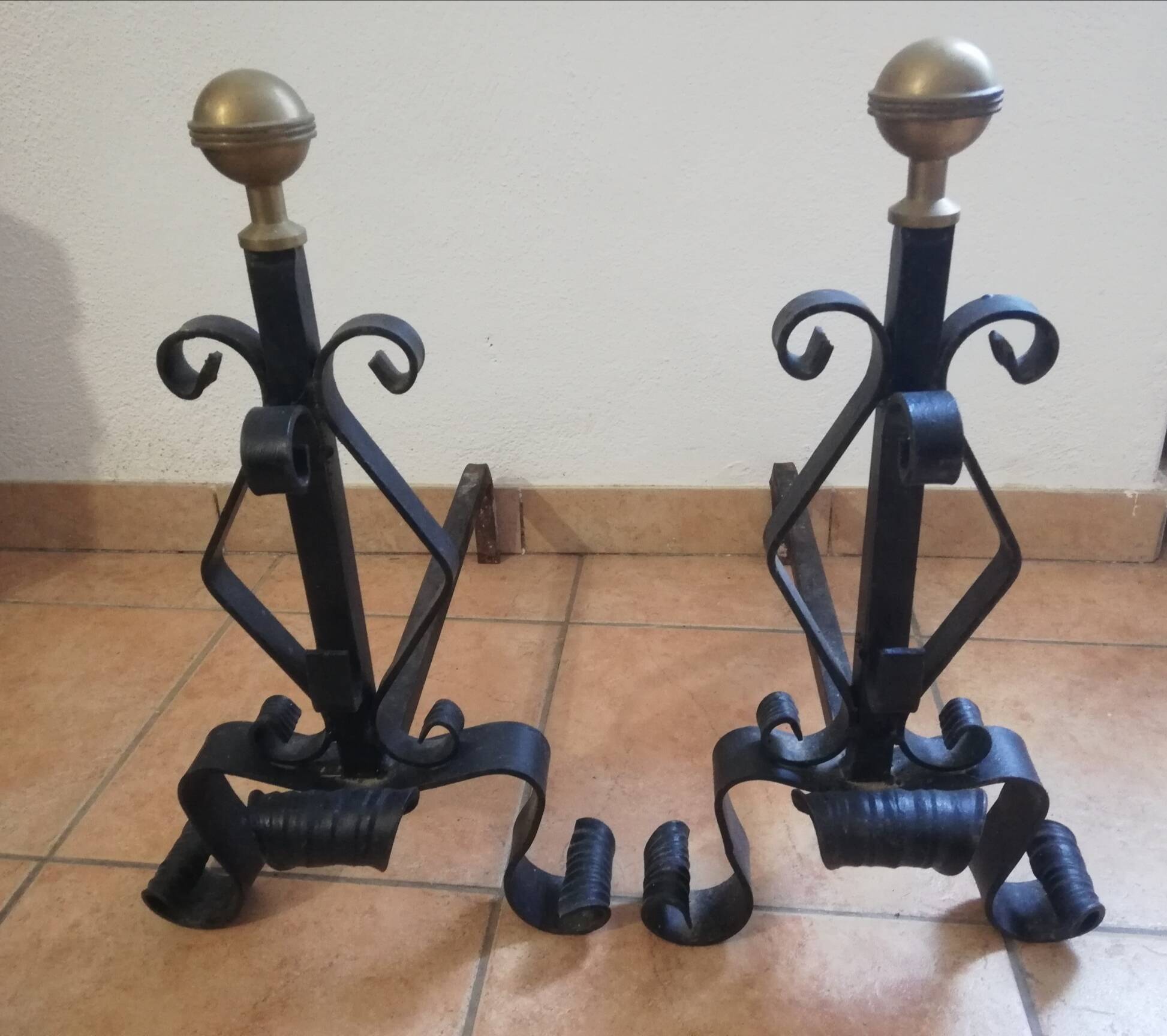 Pair of wrought iron andirons and brass ball.