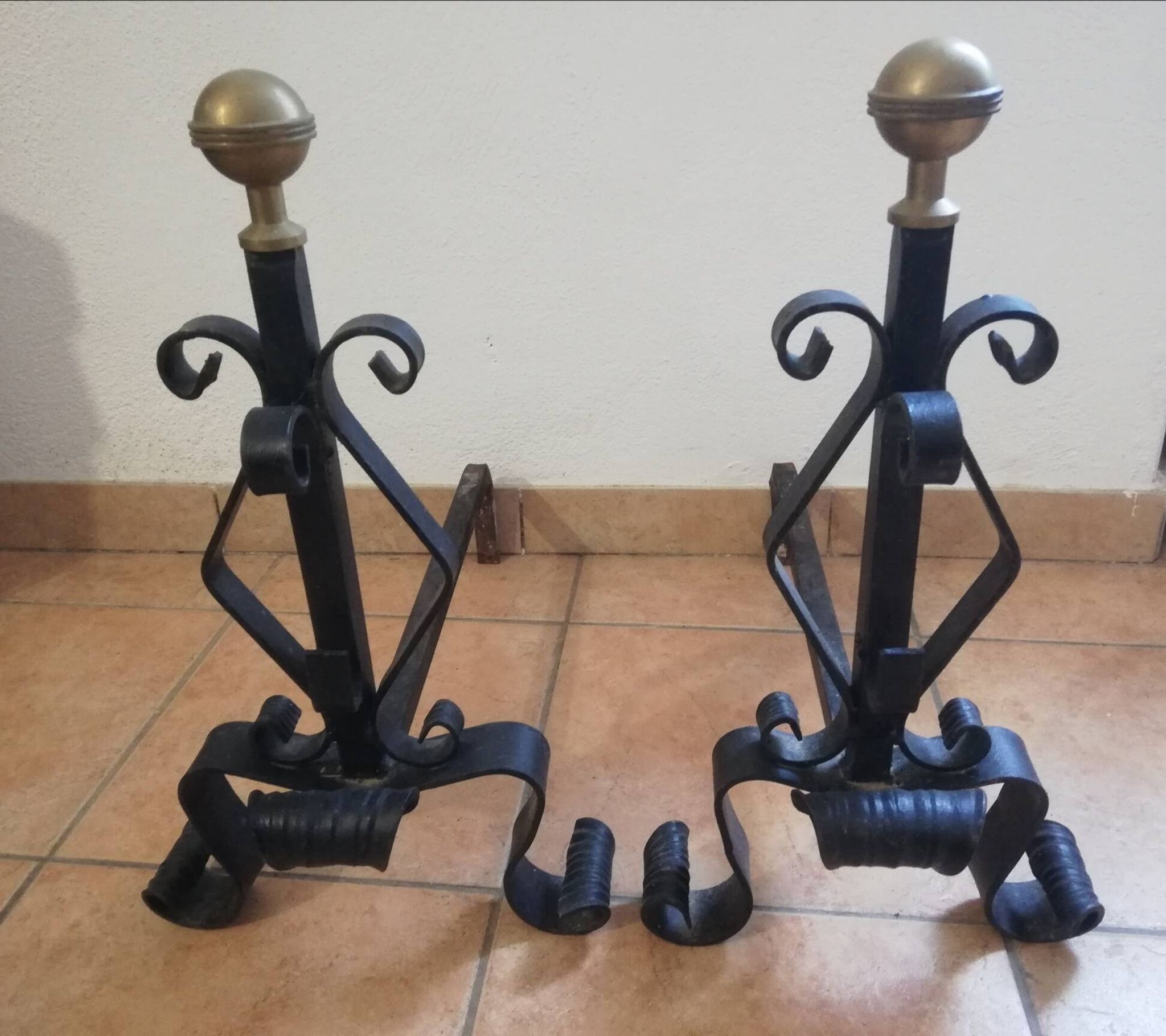 Pair of wrought iron andirons and brass ball.