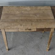 Old farmhouse table with its 2 extensions and raised legs.