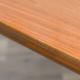 Dining table, 1960s, in walnut, slightly elliptical shape.