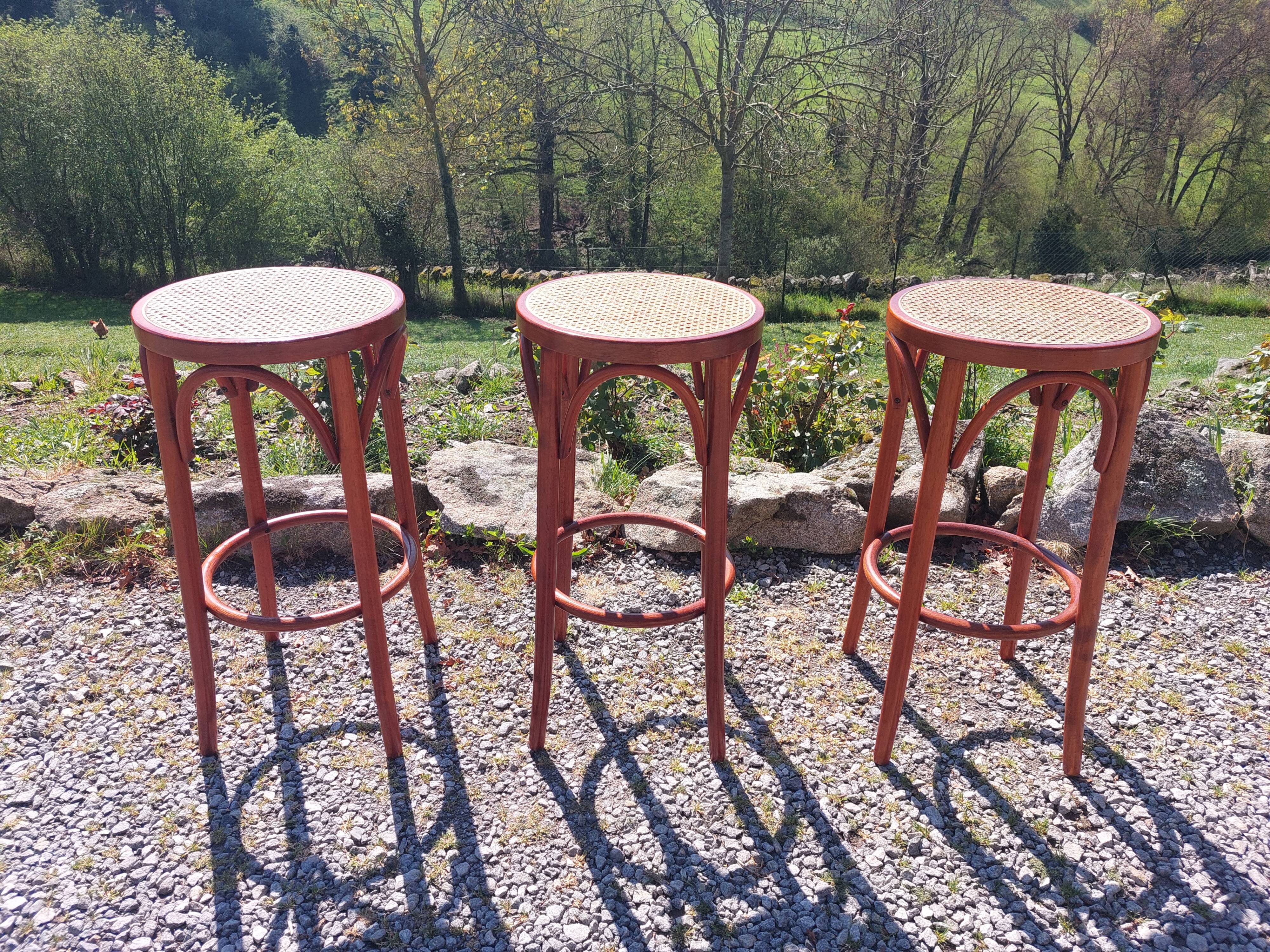 3 wooden and cane bar stools