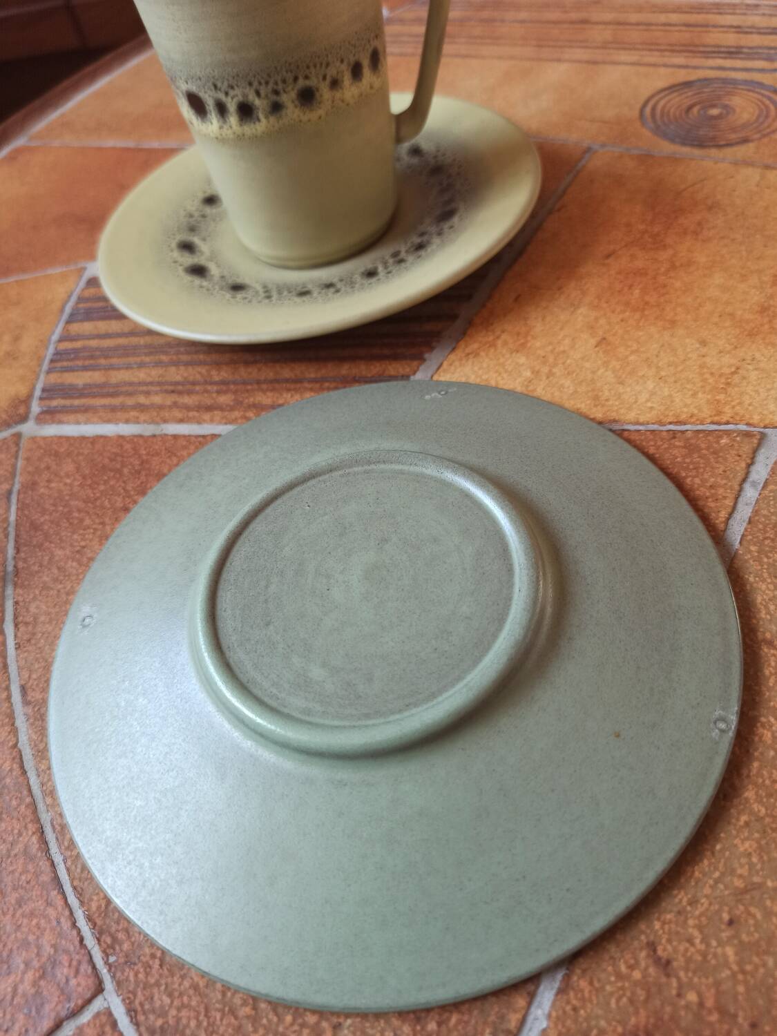 A pair of vintage glazed stoneware cups and saucers.